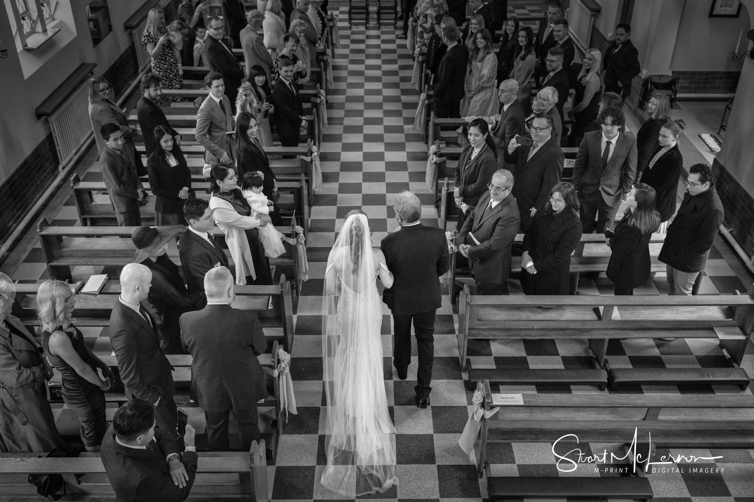 A bride walks up the aisle at St Gregory RC Church in Bollington