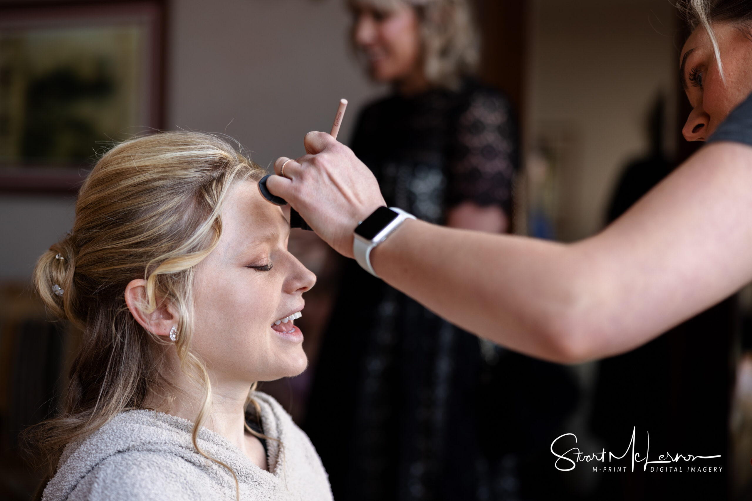 A bride having her make-up applied at Shrigley Hall